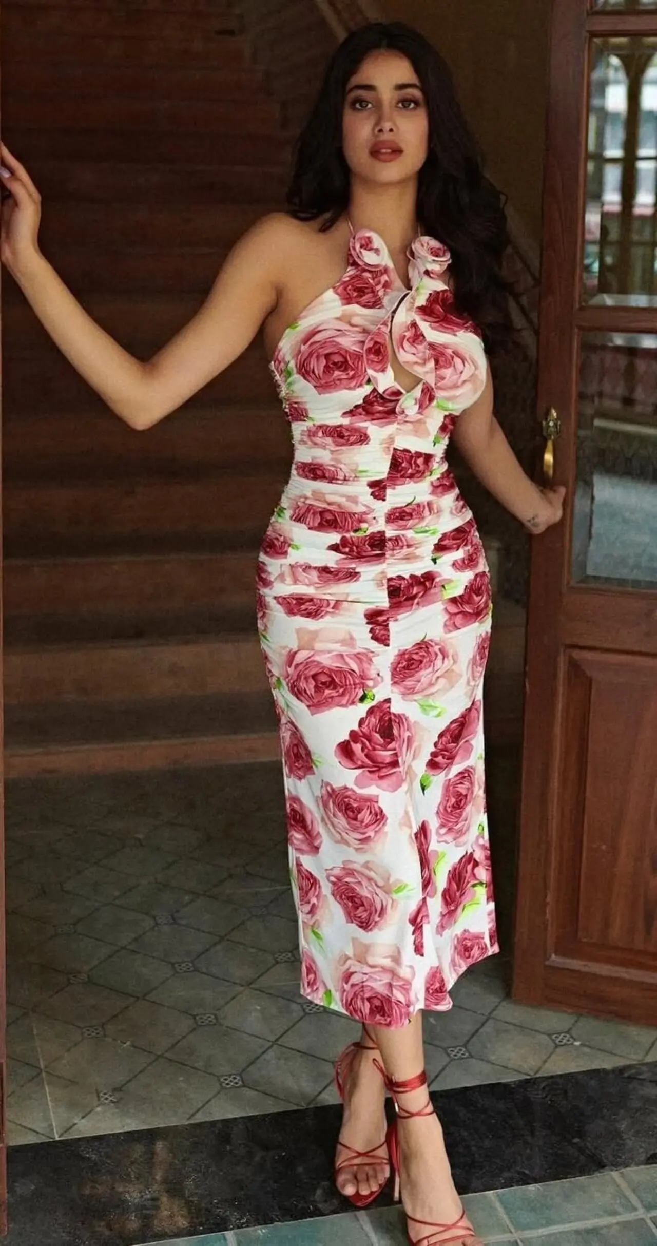Janhvi Kapoor keeps it fresh and flirty in a chic white halter-neck outfit, made unforgettable with a bold rose print.